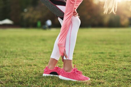 Close up of sporty woman suffering from calf painの写真素材