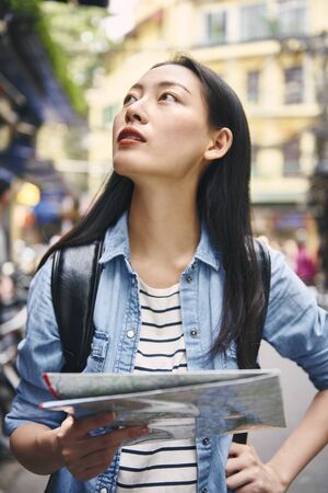Tourist looking at the directions from map