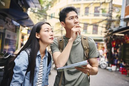 Tourists with paper map in the cityの写真素材