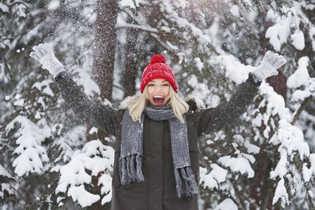 Young woman covered with fresh snowの写真素材
