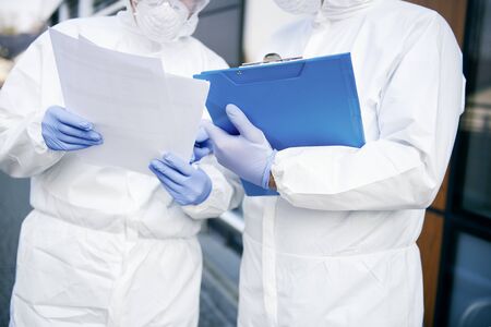 Close up of two technicians with documents