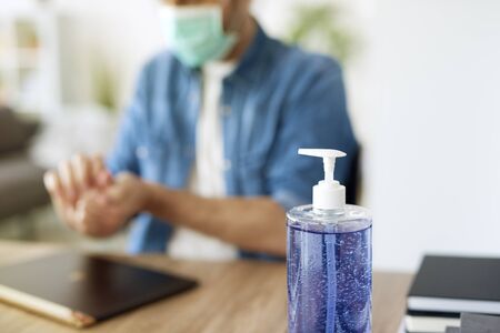 Detail of antibacterial soap and blurred working manの写真素材