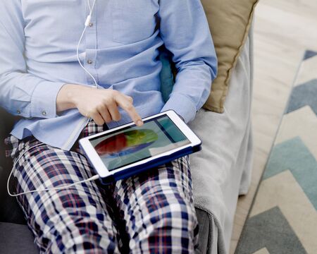 Man browsing tablet with some statistics