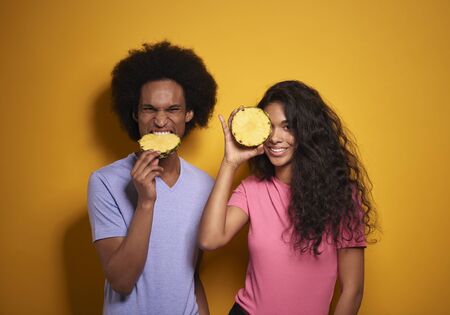 African couple with a slice of pineapple