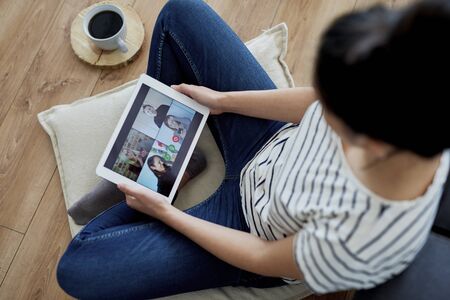 Top view of woman having a video conference with friends.