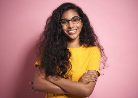 Portrait of happiness African woman in eyeglasses in studio shot.