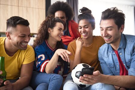 Football fans looking for something funny on the phone