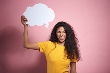 Young African woman with empty speech bubble in studio shot.