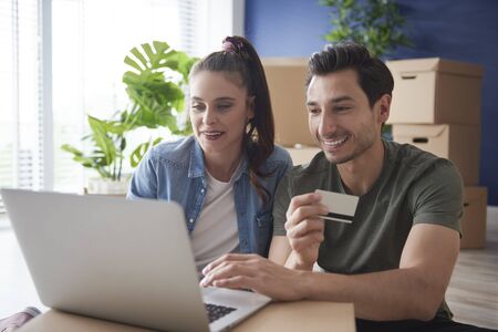 Couple doing shopping online for a new house