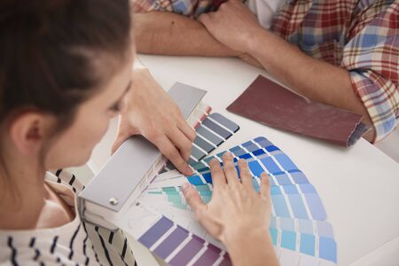 Young couple choosing new colors for the house