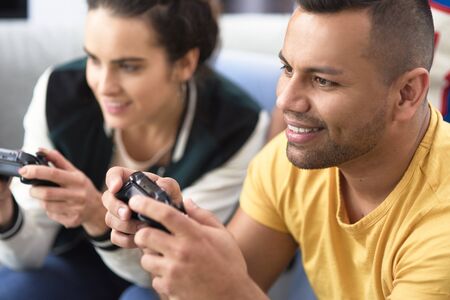 Close up of  couple playing on the consoleの写真素材