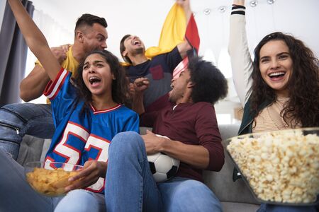 Group of football fans screaming with joy