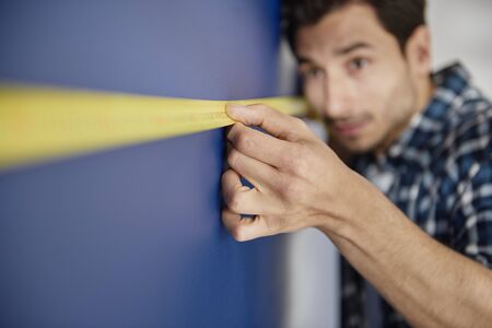 Very precise man using a tape measure の写真素材
