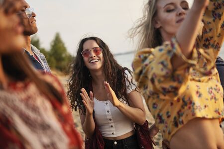 Group of young people dancing on the beach  