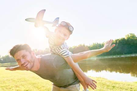 Father and son playing with a planeの写真素材
