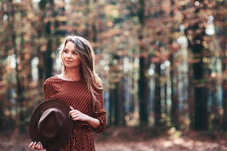 Woman walking in autumnal forestの写真素材