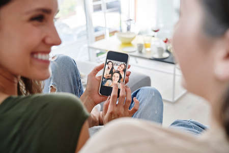 Girls browsing already taken on the phoneの写真素材