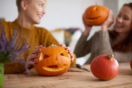 Halloween pumpkin in human hand