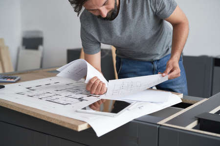 Leaning architect reviewing the projects