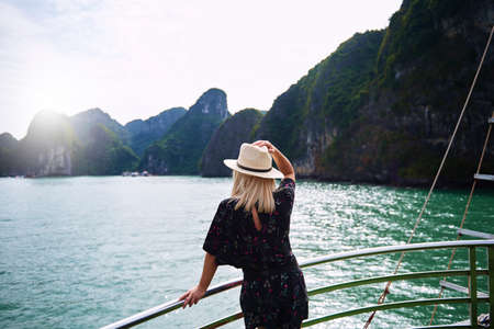 Woman admiring rock formations in Ha Long Bay Vietnamの写真素材