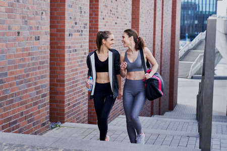 Two young smiling beautiful women going to trainingの写真素材