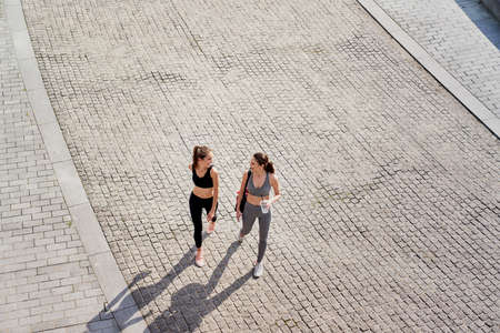 Top view of two women going in training clothes outdoorの写真素材