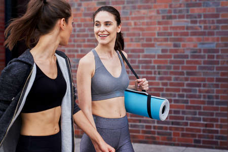 Two women coming back from training and talkingの写真素材