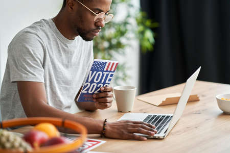 Man browsing informational leaflet of election
