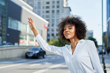Businesswoman catching a cab on the streetsの写真素材
