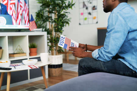 Black man interested in watching TV of USA election