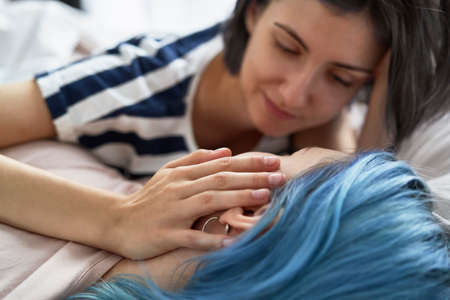 Close up of lesbian couple stroking the cheekの写真素材