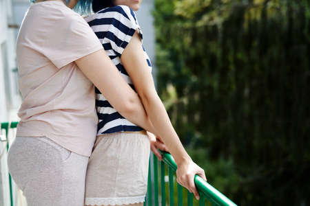 Unrecognizable lesbian couple hugging outdoorsの写真素材