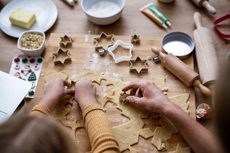 Top view of hands preparing Christmas cookiesの写真素材