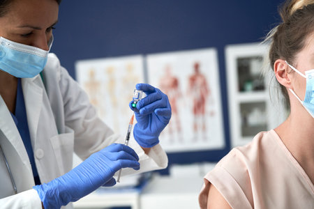 Close up of doctor vaccinates the patient against the virusの写真素材