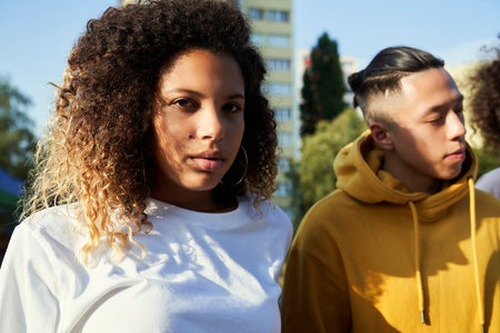 Portrait of serious young woman standing with friend
