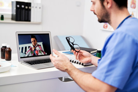 Doctor during video consultation with a sick patientの写真素材