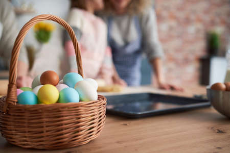 Close up of wicker basket full of Easter eggs