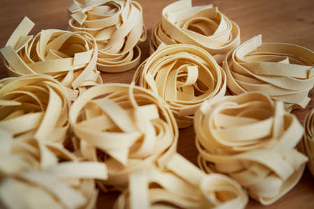 Close up of raw tagliatelle on the kitchen counterの写真素材