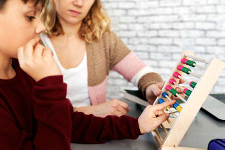 Side view of boy learning to count with an abacusの写真素材