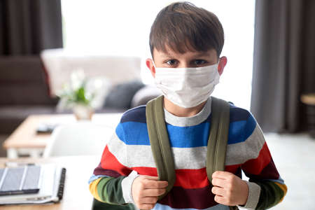 Close up of portrait schoolboy in protective face maskの写真素材