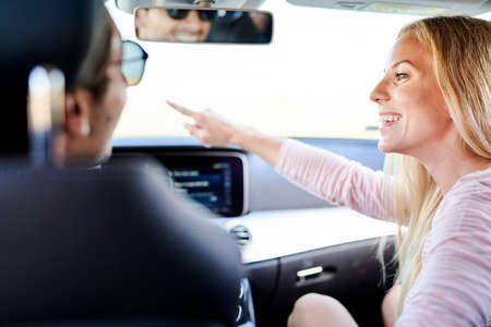 Rear view of woman pointing the man where to goの写真素材