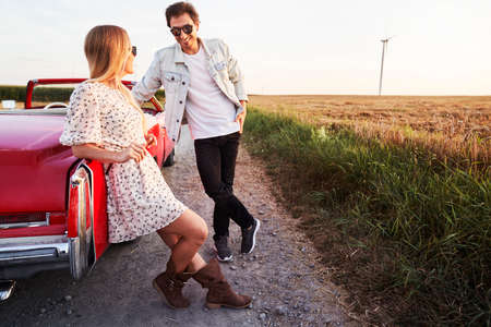 Couple on a date during a car trip at sunsetの写真素材