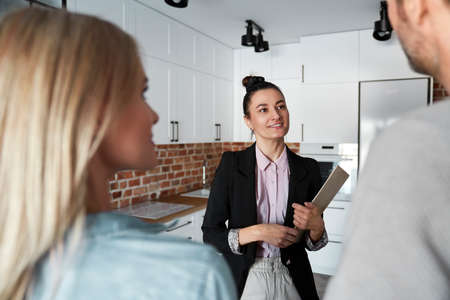 Real estate agent showing new apartment to a coupleの写真素材