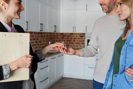 Real estate agent gives the keys to the clientsの写真素材