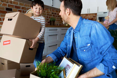 Little boy helping with the moveの写真素材