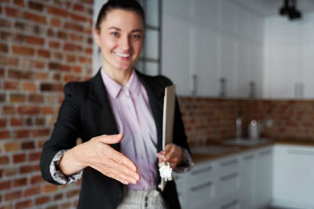 Real estate agent reaches out for a handshakeの写真素材