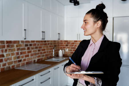 Smiling real estate agent in new apartmentの写真素材