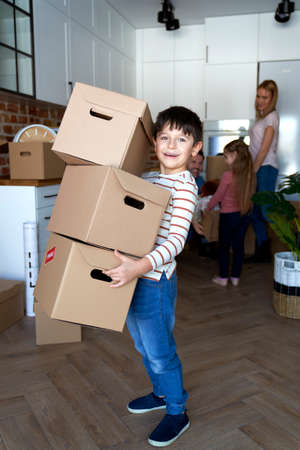Portrait of happy boy holding a cardboard boxesの写真素材