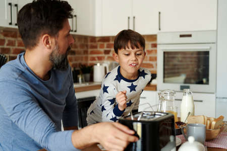 Father and son having breakfast in the morningの写真素材
