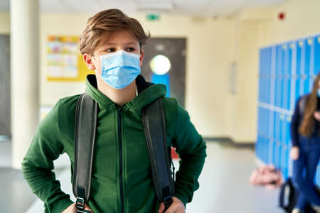 Close up of student in protective mask at schoolの写真素材